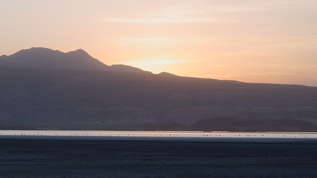 Sunset over mountains and lake